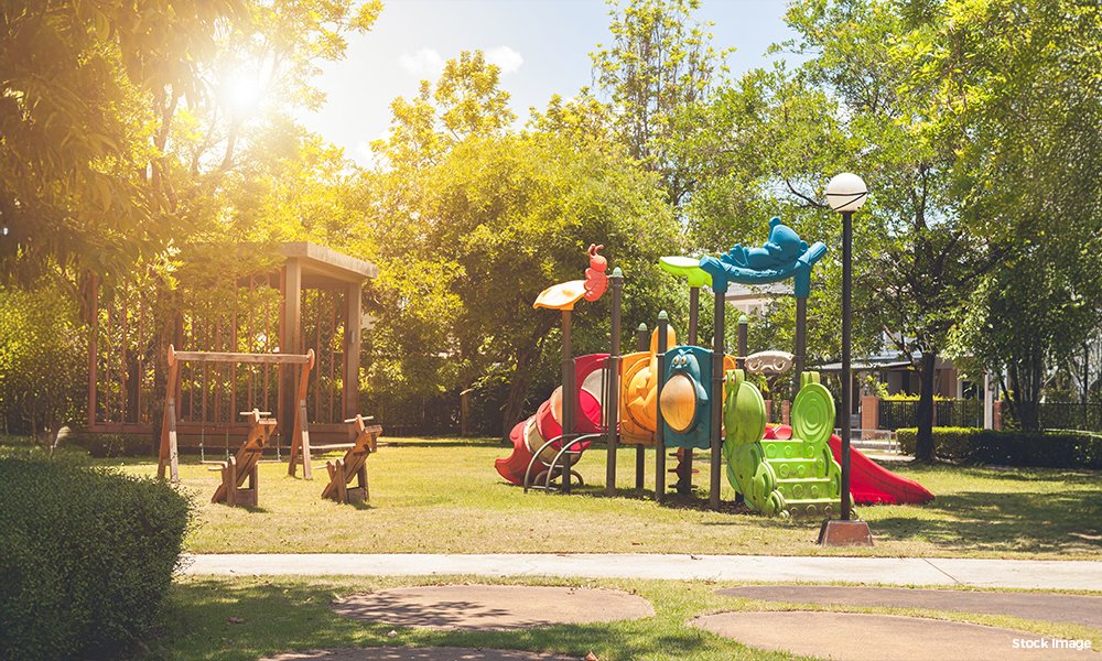 Children's play area amid landscaped greens
